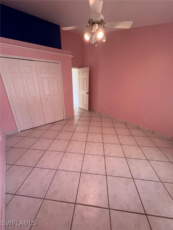 2875 18th Ave SE, Naples, FL 34117 - unfurnished bedroom with light tile patterned flooring, a ceiling fan, and a closet