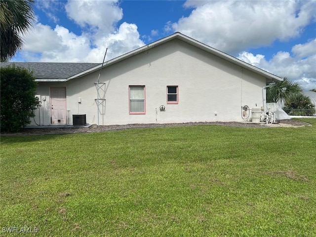 2875 18th Ave SE, Naples, FL 34117 - view of property exterior with central AC, stucco siding, and a yard