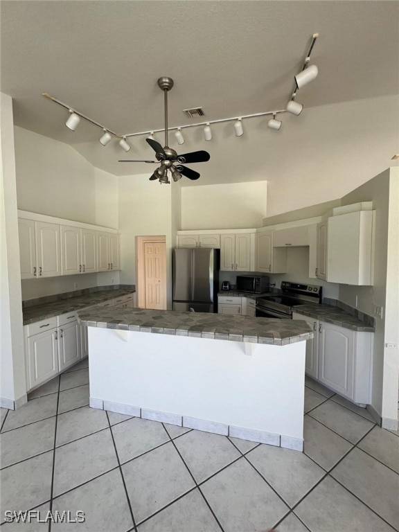 2875 18th Ave SE, Naples, FL 34117 - kitchen featuring a large island, ceiling fan, tile countertops, rail lighting, and appliances with stainless steel finishes