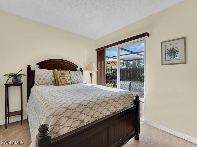 bedroom featuring baseboards, access to exterior, a textured ceiling, and light colored carpet