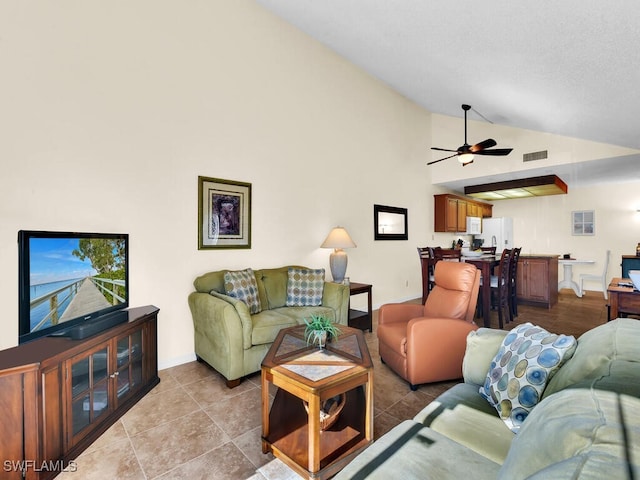 living area with visible vents, ceiling fan, high vaulted ceiling, and baseboards