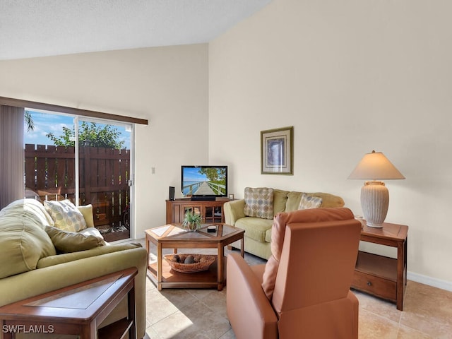 living room with light tile patterned flooring, high vaulted ceiling, and baseboards
