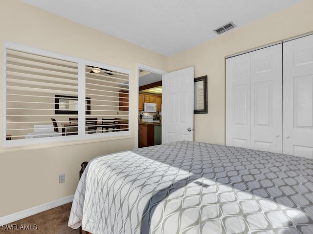 carpeted bedroom with baseboards, visible vents, and a closet