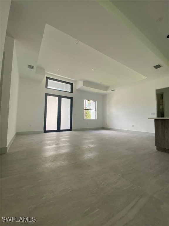 1918 Blue Sage Dr, Naples, FL 34117 - unfurnished living room featuring finished concrete floors and baseboards