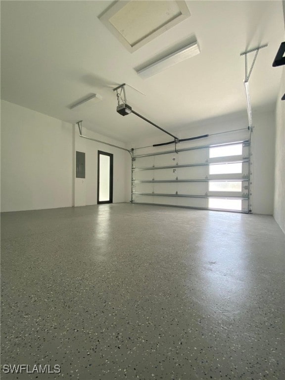 garage featuring a garage door opener and electric panel
