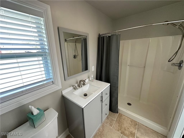 401 Candlewick Cir E, Lehigh Acres, FL 33936 - full bathroom featuring a stall shower, vanity, stone finish flooring, and toilet