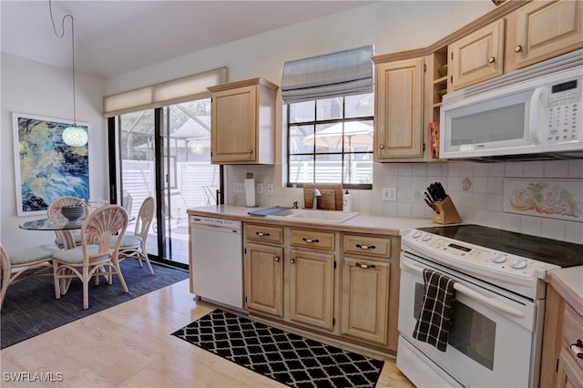 kitchen with backsplash, light wood-type flooring, light countertops, light brown cabinets, and white appliances