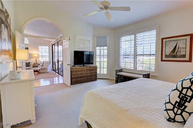 bedroom with a ceiling fan, vaulted ceiling, access to exterior, and carpet