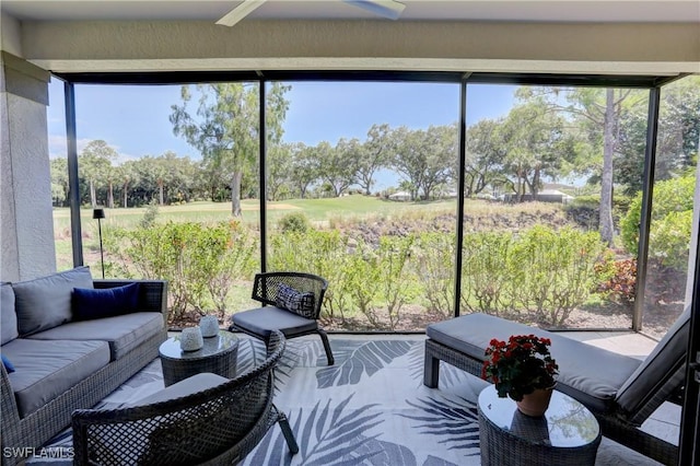 sunroom / solarium featuring ceiling fan, golf course view, a healthy amount of sunlight, and an outdoor hangout area