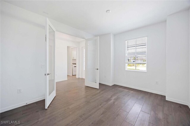 unfurnished room with french doors, baseboards, and dark wood-style floors