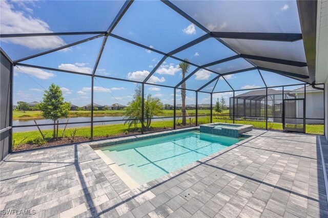 view of swimming pool with a lanai, a patio, a water view, and a pool with connected hot tub
