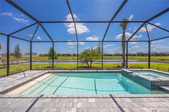 view of pool featuring a water view, a pool with connected hot tub, a lanai, and a patio area