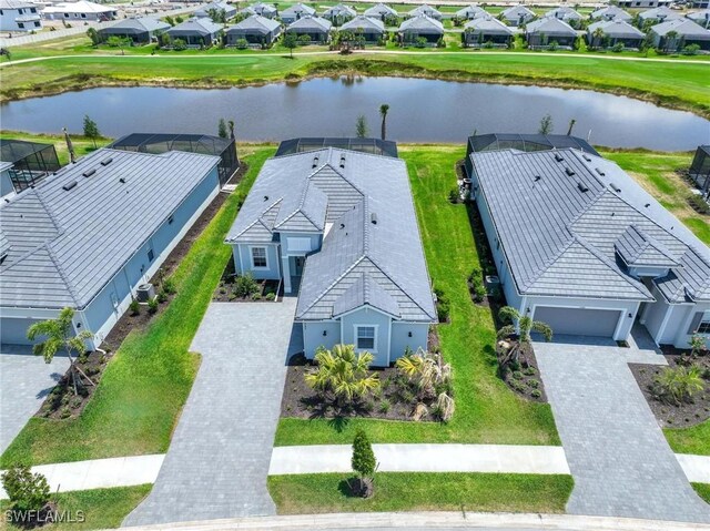 birds eye view of property with a water view and a residential view