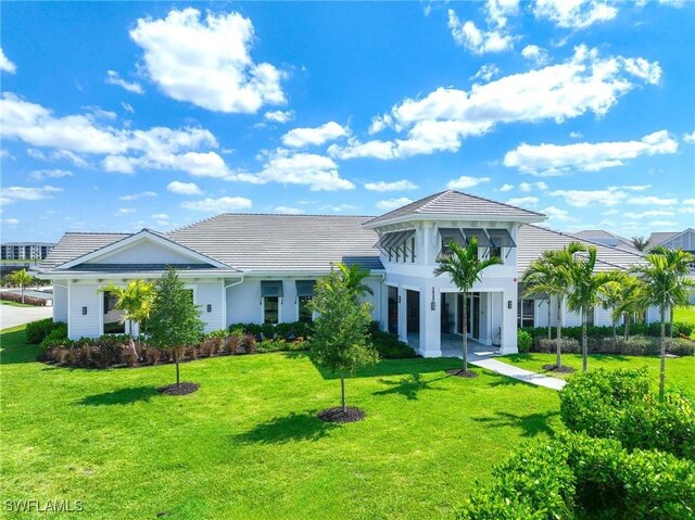 view of front of property with stucco siding and a front lawn