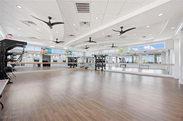exercise room with visible vents, a ceiling fan, and a paneled ceiling
