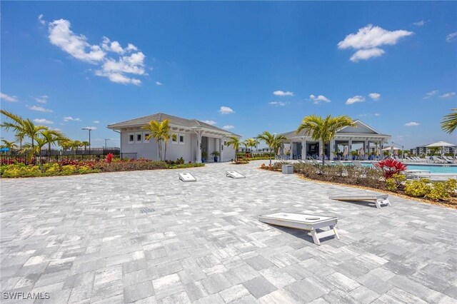 exterior space featuring a swimming pool and fence
