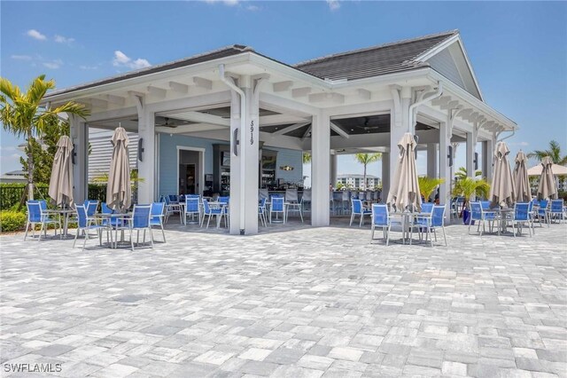 view of property's community featuring a patio and outdoor dining area