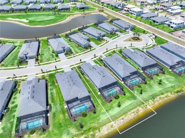 birds eye view of property with a residential view and a water view