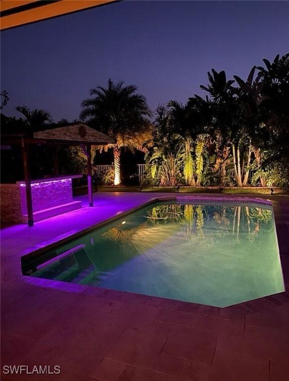 3402 Tigris Ln, Naples, FL 34119 - pool at twilight with an outdoor pool, a gazebo, and a patio area
