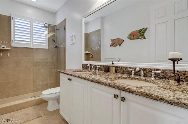 3402 Tigris Ln, Naples, FL 34119 - bathroom with toilet, tiled shower, tile patterned flooring, and a sink