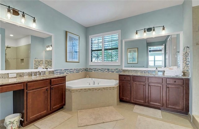 3402 Tigris Ln, Naples, FL 34119 - bathroom with a tile shower, tile patterned flooring, two vanities, a sink, and a garden tub