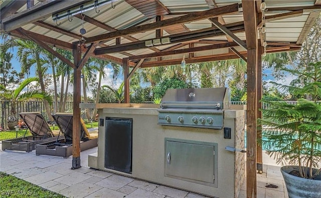 3402 Tigris Ln, Naples, FL 34119 - view of patio with exterior kitchen, a gazebo, grilling area, and fence