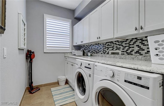 3402 Tigris Ln, Naples, FL 34119 - laundry room featuring a sink, cabinet space, independent washer and dryer, tile patterned floors, and baseboards
