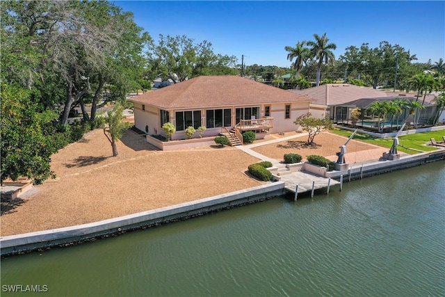 230 5th St, Bonita Springs, FL 34134 - back of property featuring a deck with water view and stucco siding