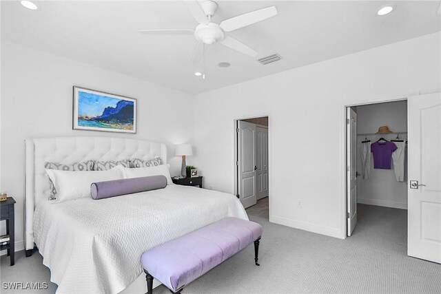 2949 Heritage Pines Dr, Fort Myers, FL 33905 - carpeted bedroom with a walk in closet, recessed lighting, a ceiling fan, a closet, and baseboards