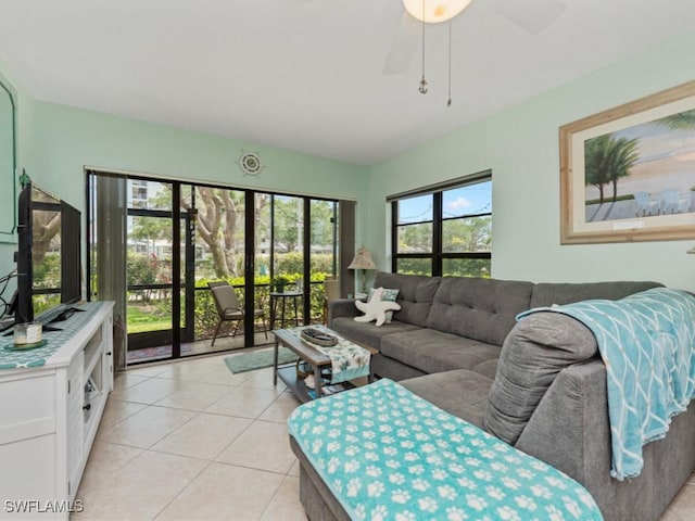 living area with a ceiling fan and light tile patterned floors