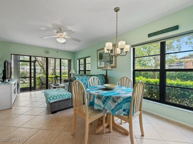 dining space featuring baseboards, ceiling fan with notable chandelier, and light tile patterned flooring