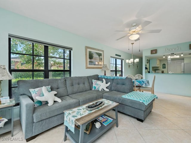 living room with light tile patterned floors and ceiling fan with notable chandelier