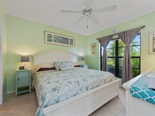 bedroom with baseboards, ceiling fan, and light tile patterned flooring