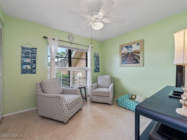 office area featuring light tile patterned floors, baseboards, and ceiling fan