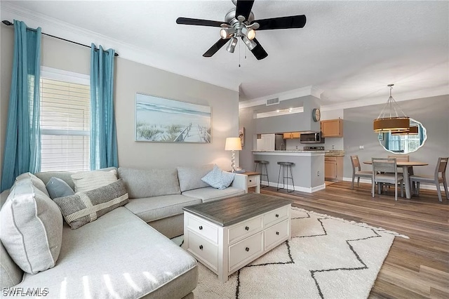 11541 Villa Grand Unit 817, Fort Myers, FL 33913 - living area featuring crown molding, ceiling fan, visible vents, and light wood-style flooring