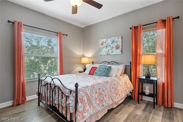 11541 Villa Grand Unit 817, Fort Myers, FL 33913 - bedroom featuring baseboards, multiple windows, and wood finished floors