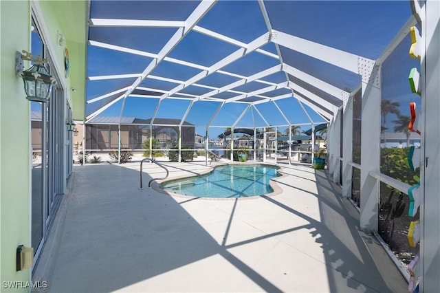pool featuring glass enclosure and a patio area