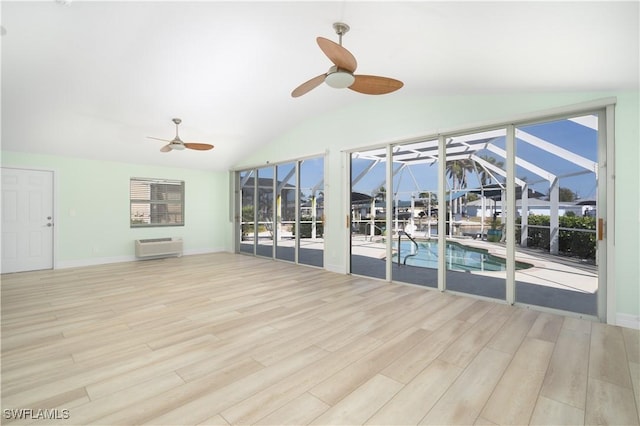 unfurnished sunroom with a ceiling fan and an AC wall unit