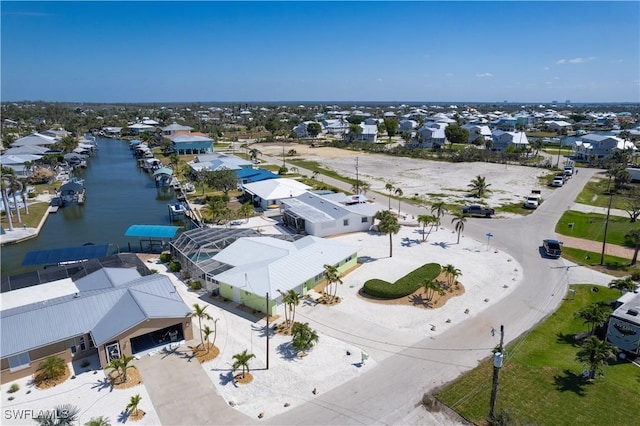 birds eye view of property featuring a water view and a residential view