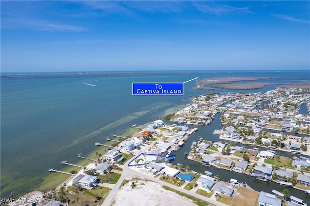 drone / aerial view with a residential view and a water view