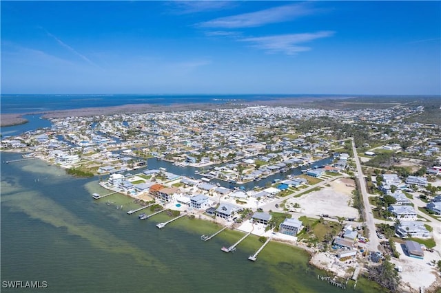 drone / aerial view with a residential view and a water view