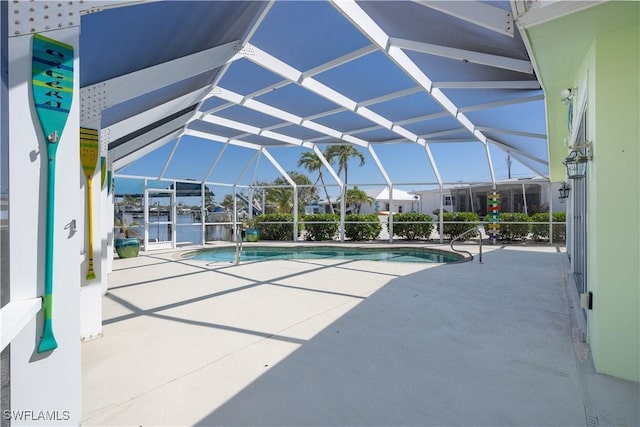pool featuring a patio and glass enclosure