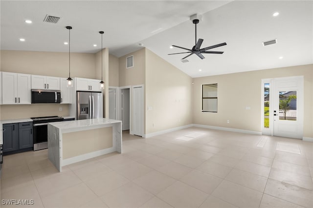 1008 NW 36th Pl, Cape Coral, FL 33993 - kitchen with stainless steel appliances, high vaulted ceiling, and visible vents