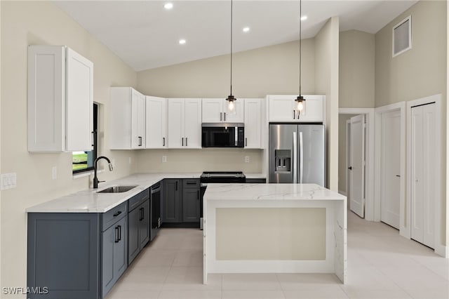 1008 NW 36th Pl, Cape Coral, FL 33993 - kitchen featuring a sink, light stone counters, a kitchen island, and stainless steel appliances