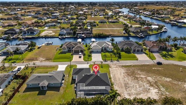 1008 NW 36th Pl, Cape Coral, FL 33993 - birds eye view of property featuring a water view and a residential view