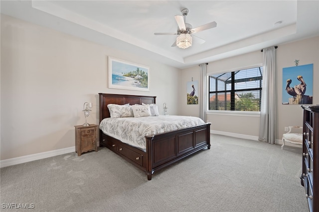 11498 Tiverton Trce, Fort Myers, FL 33913 - bedroom featuring a tray ceiling, light carpet, and baseboards