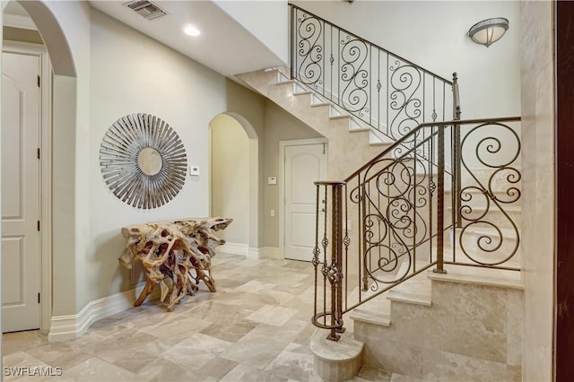 1947 Gordon River Ln, Naples, FL 34104 - stairway featuring arched walkways, baseboards, visible vents, and marble finish floor