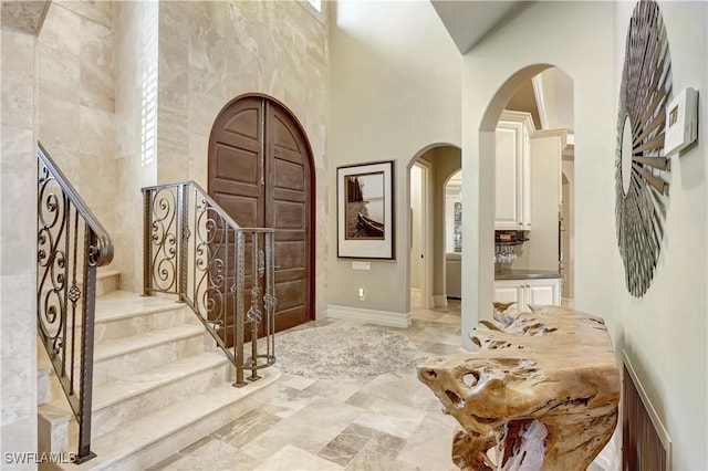 1947 Gordon River Ln, Naples, FL 34104 - entryway with stairs, arched walkways, marble finish floor, and a towering ceiling