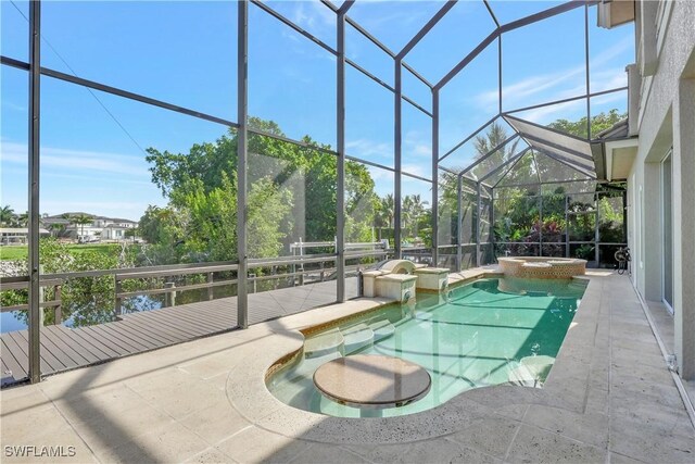 1947 Gordon River Ln, Naples, FL 34104 - view of swimming pool with glass enclosure, a pool with connected hot tub, and a patio