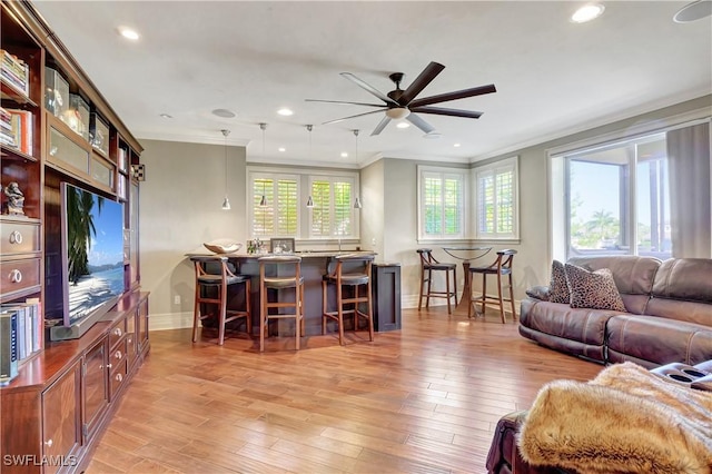 1947 Gordon River Ln, Naples, FL 34104 - living area with crown molding, a ceiling fan, baseboards, and a healthy amount of sunlight